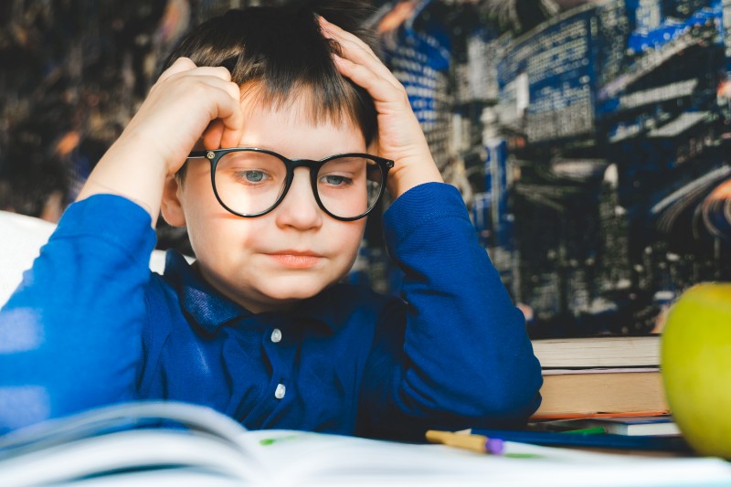 Cute kid studying book